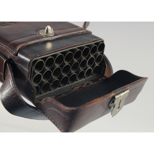 9 - A LEATHER CARTRIDGE CASE 17cm x 11cm, with cross guns in relief and leather strap.