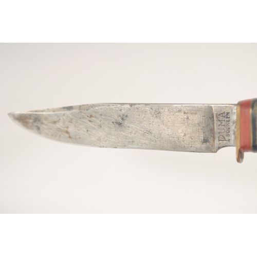 95 - A PUMA KNIFE, with antler handle, in a leather sheath, 7.5