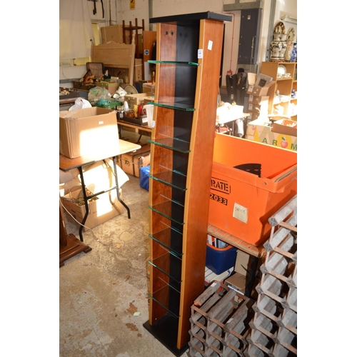 100 - A tall narrow shelving unit.