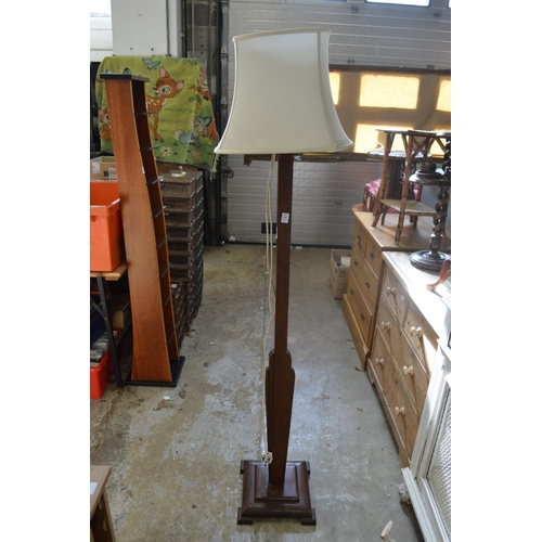 136 - An art deco oak floor standing lamp.