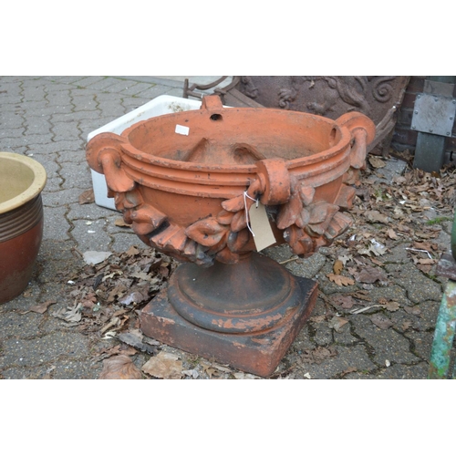 14 - A good set of three large terracotta classical shaped pedestal garden urns/planters.