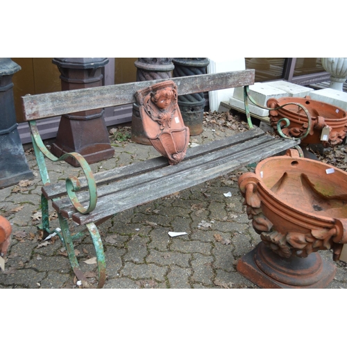 15 - A wrought iron and wooden slatted garden bench.