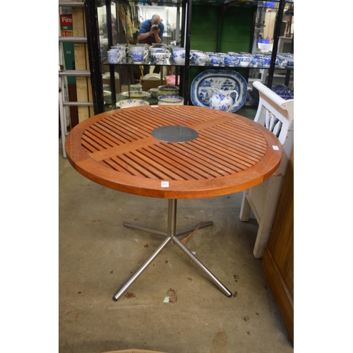 161 - A teak and metal circular garden table.