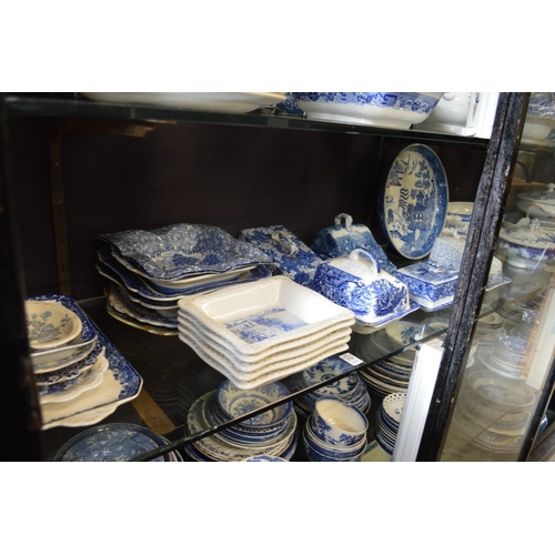 174 - A quantity of blue and white serving dishes, cheese dishes etc.