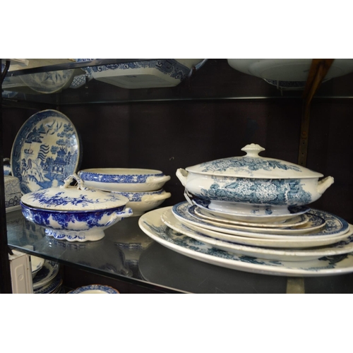 174 - A quantity of blue and white serving dishes, cheese dishes etc.