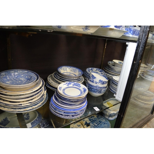 175 - A quantity of blue and white plates, saucers, bowls.