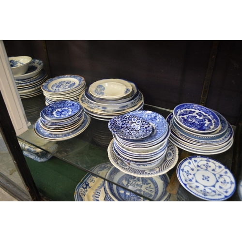 175 - A quantity of blue and white plates, saucers, bowls.