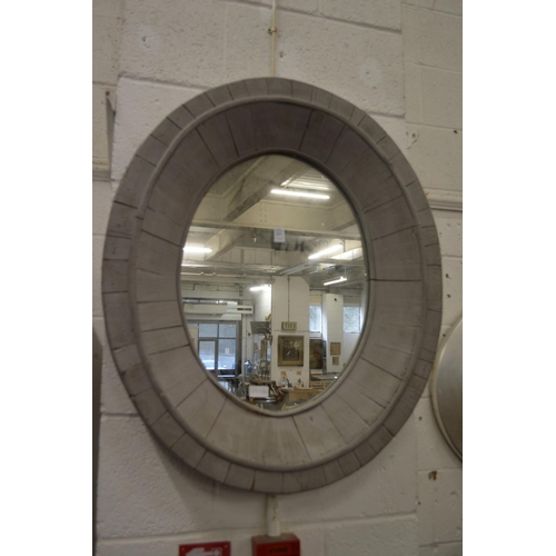 227 - A grey painted oval wall mirror.