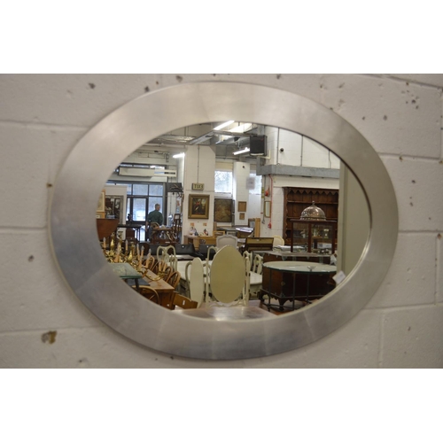 230 - A silver framed oval wall mirror.