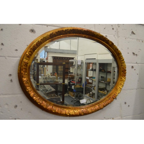 233 - Decorative gilt framed oval wall mirror.