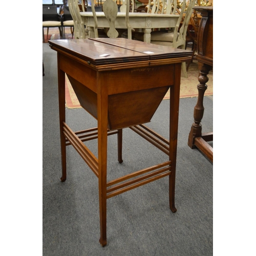 234 - An Edwardian mahogany work table with bi-fold top.