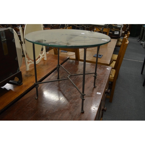 235 - A circular glass coffee table with wrought iron base.