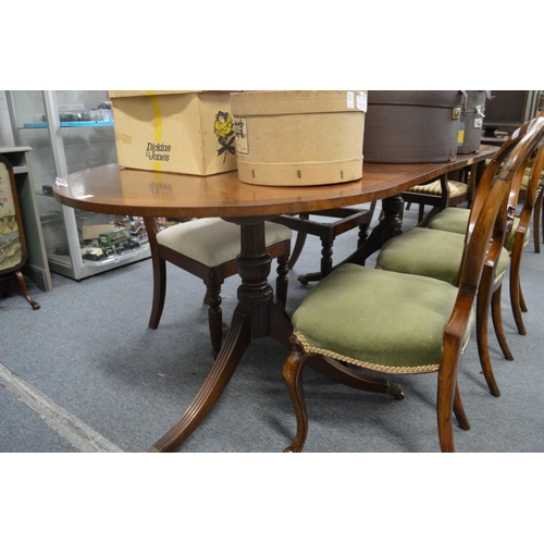 238 - A mahogany twin pedestal dining table with one leaf.