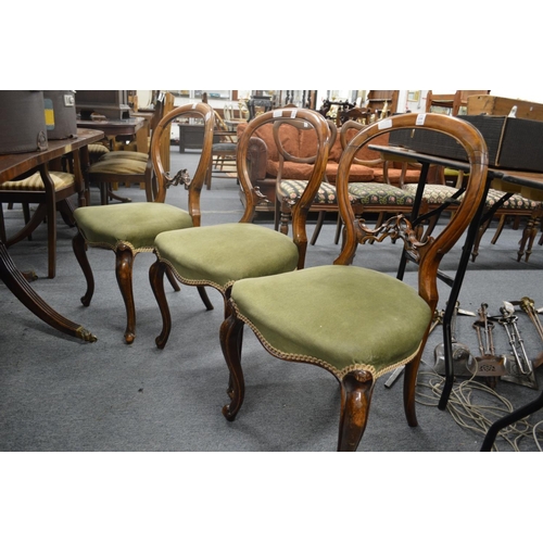 239 - A set of three Victorian walnut dining chairs (faults).