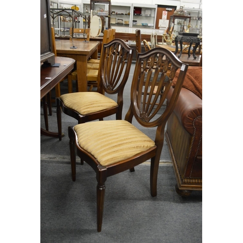 242 - A set of six shield back dining chairs, two with arms.