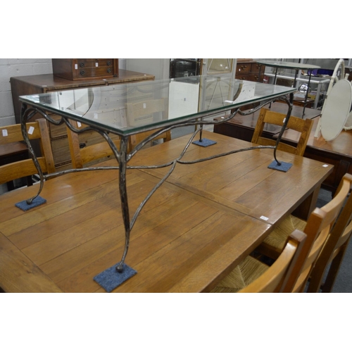 243 - Glass top coffee table with wrought iron base.