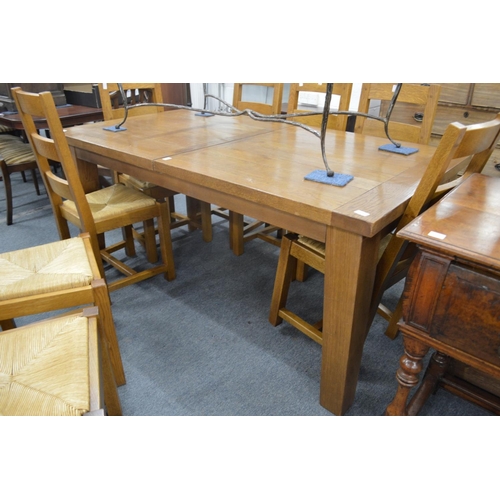 244 - A good modern oak extending dining table.