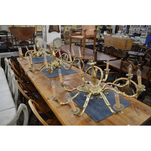 253 - A set of three good quality heavy brass eight branch chandeliers.