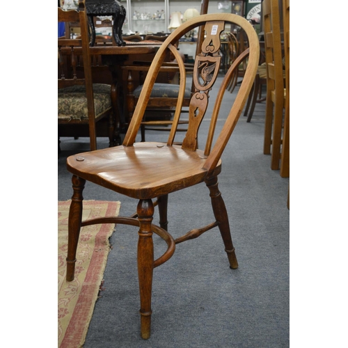 254 - A set of ten beech and elm splat back windsor dining chairs, the backs carved with a liver bird.