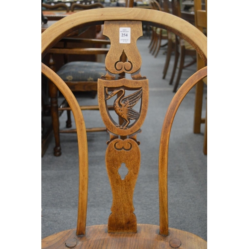 254 - A set of ten beech and elm splat back windsor dining chairs, the backs carved with a liver bird.