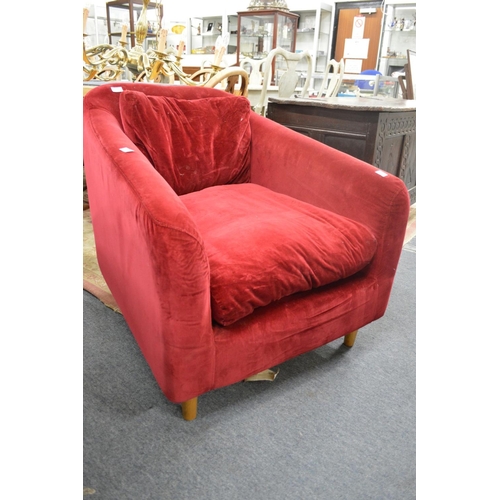 270 - A red velvet upholstered modern deep armchair.