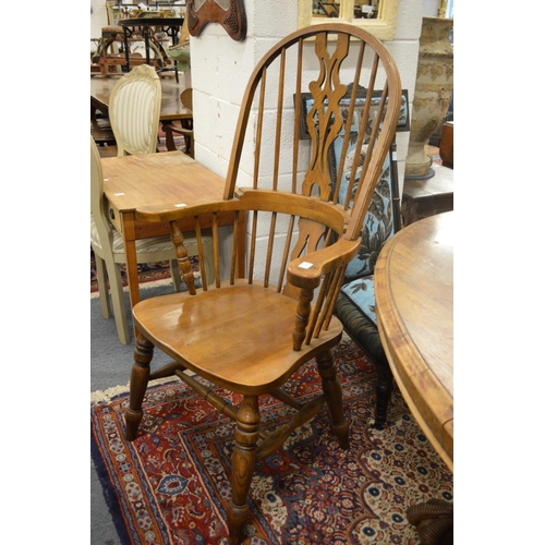 275 - A Windsor style broad armchair.