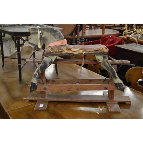 283 - An early small painted rocking horse on pine stand.