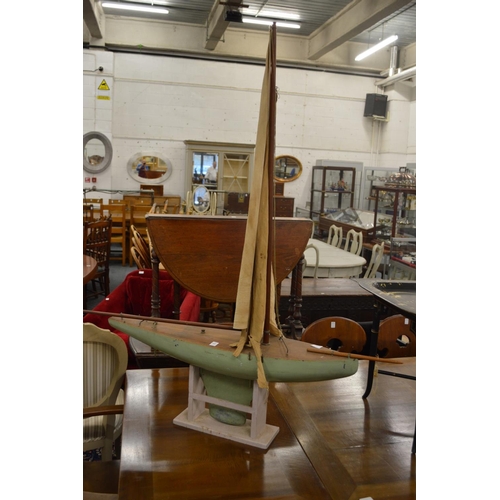 285 - A painted model of a yacht on stand.