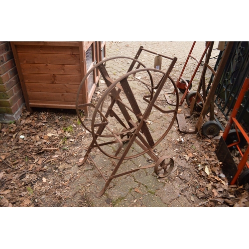 29 - A wrought iron garden hose frame.