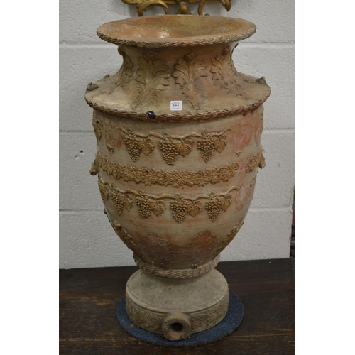 294 - A large salt glazed vase shaped urn with grape and vine decoration.