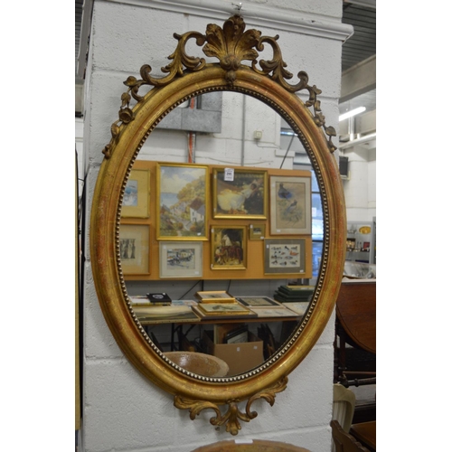 295 - A good gilt framed oval wall mirror.