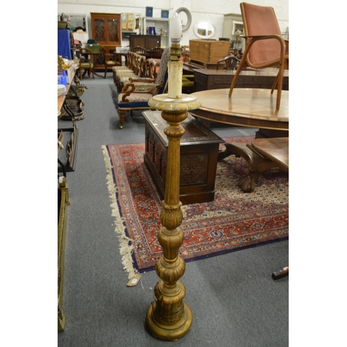 300 - A carved giltwood floor standing lamp.