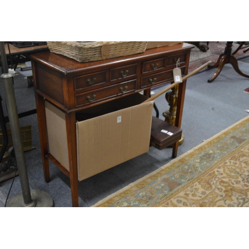 301 - A mahogany two tier side table with six small drawers.