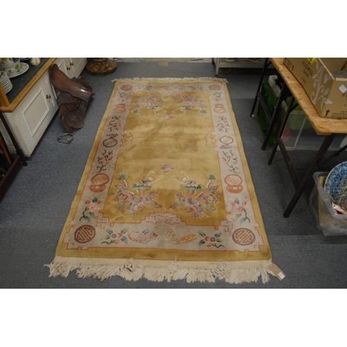 303 - A Chinese gold ground rug 7' 4