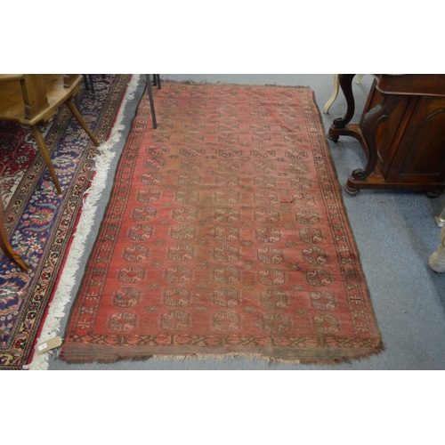 308 - An old Bokhara carpet, worn 7' x 4' 1