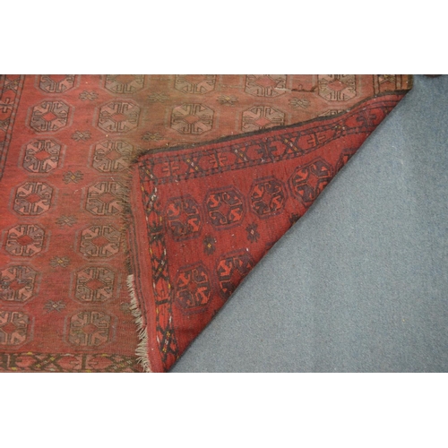 308 - An old Bokhara carpet, worn 7' x 4' 1