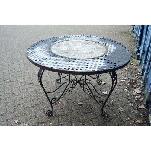 32 - A wrought iron and composite circular garden table.