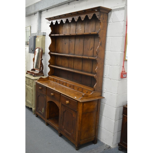 322 - A good elm dresser with triple delft rack, six spice drawers, the base with three frieze drawers an ... 