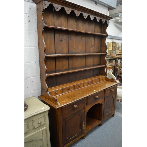 322 - A good elm dresser with triple delft rack, six spice drawers, the base with three frieze drawers an ... 