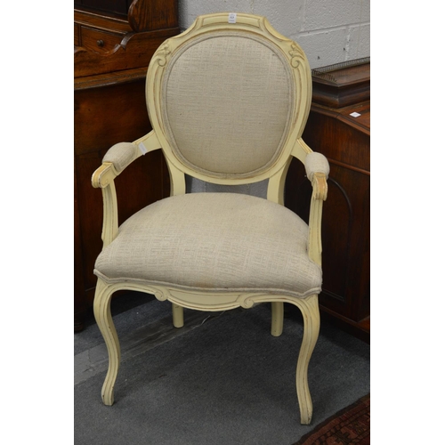 323 - A French style upholstered open armchair with cream painted frame.