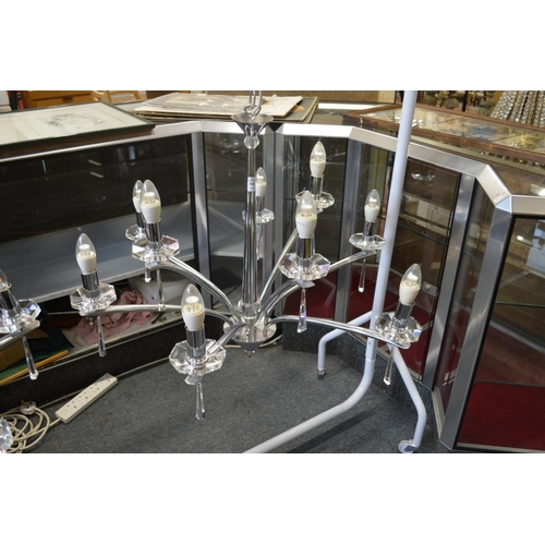 344 - A stylish chrome plated and cut glass nine branch chandelier.