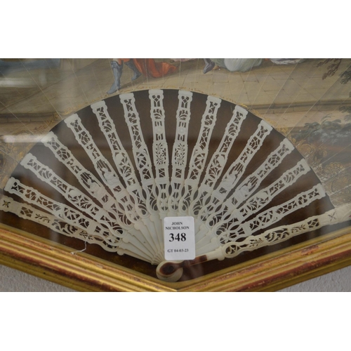 348 - A gilt wood display case containing a decorative painted French fan.