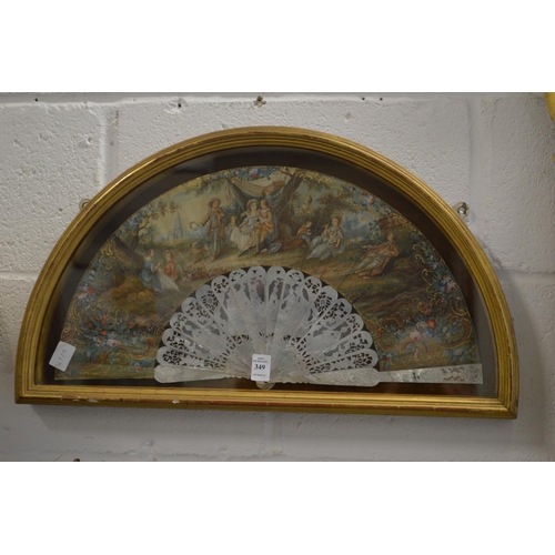 349 - A gilt wood display case containing a decorative painted French fan.