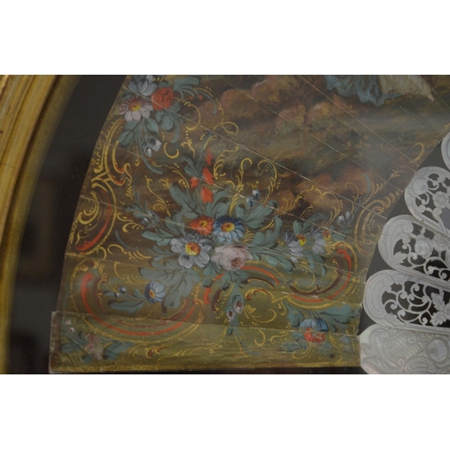 349 - A gilt wood display case containing a decorative painted French fan.