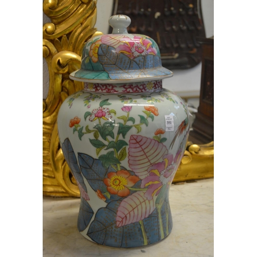 351 - A pair of colourfully decorated Chinese temple jars and covers.