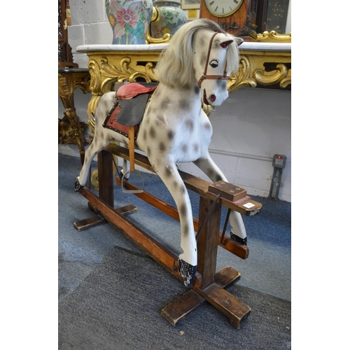 356 - A good painted rocking horse on pine stand.