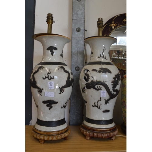 36 - A large pair of Chinese pottery vase lamps (faults).