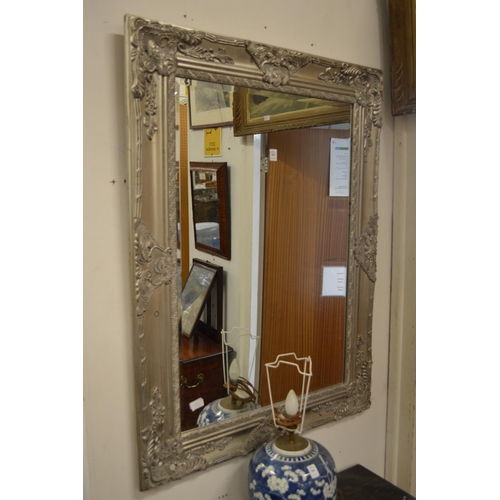 365 - A large decorative gilt framed mirror.