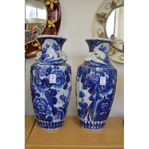 38 - A pair of Oriental blue and white vases.