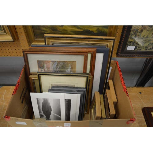 394 - A box of paintings and prints.